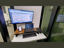Load image into Gallery viewer, Work pod 'Delta M' interior with monitor, laptop, keyboard, and other accessories.