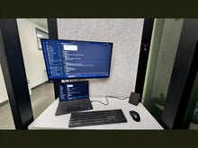 Load image into Gallery viewer, Work pod 'Richmond M' interior with monitor, laptop, keyboard, and other accessories.
