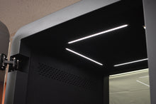 Load image into Gallery viewer, Lighting and hidden door higes Office Phone Booth 'delta S'. Black dark interior office pod. Gawayer Canada Inc. No ROOM for distractions. Made in Canada.