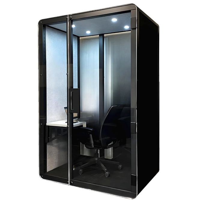 Phone booth, black with compact desk and office chair. Soundproofing for private phone call and distraction minimization. LED lights and ventilation for comfortable working sessions.